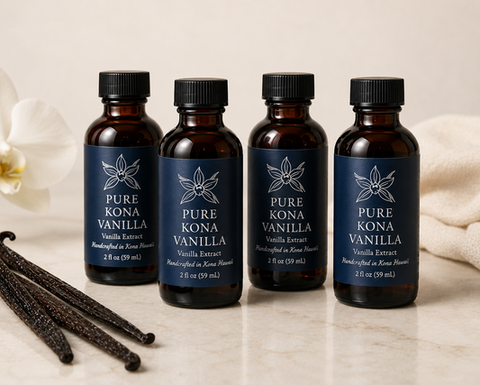 Four Pure Kona Vanilla Extract 2fl oz bottles with branded labels, handcrafted in Kona Hawaii